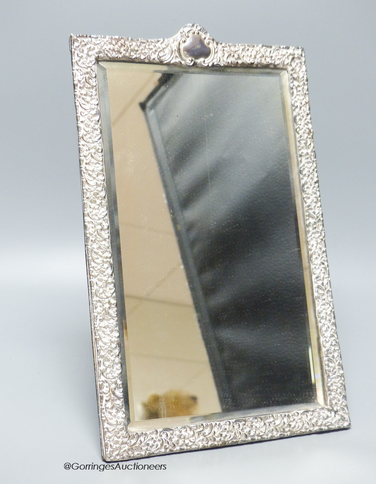 An Edwardian repousse silver mounted rectangular easel mirror, Deakin & Francis, Birmingham, 1904, 32.7cm.